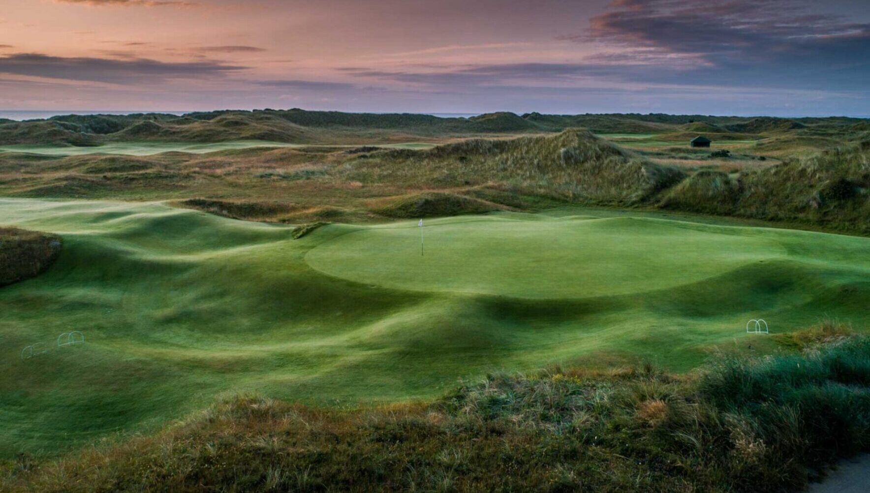 A green golf course with no people in it.