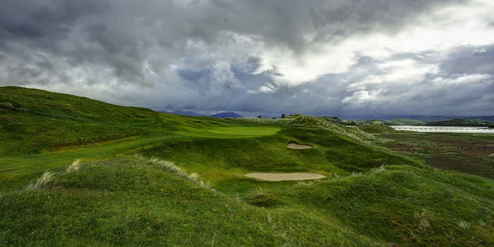 A view of the golf course from behind a hill.