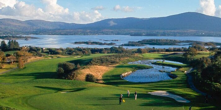 A view of some water and grass on the golf course.