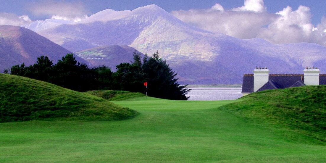 A golf course with mountains in the background.